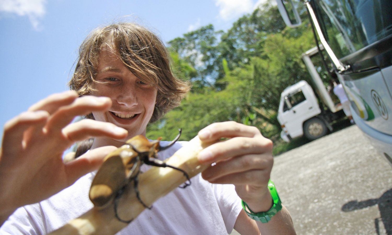 student playing with giant beetle in Costa Rica