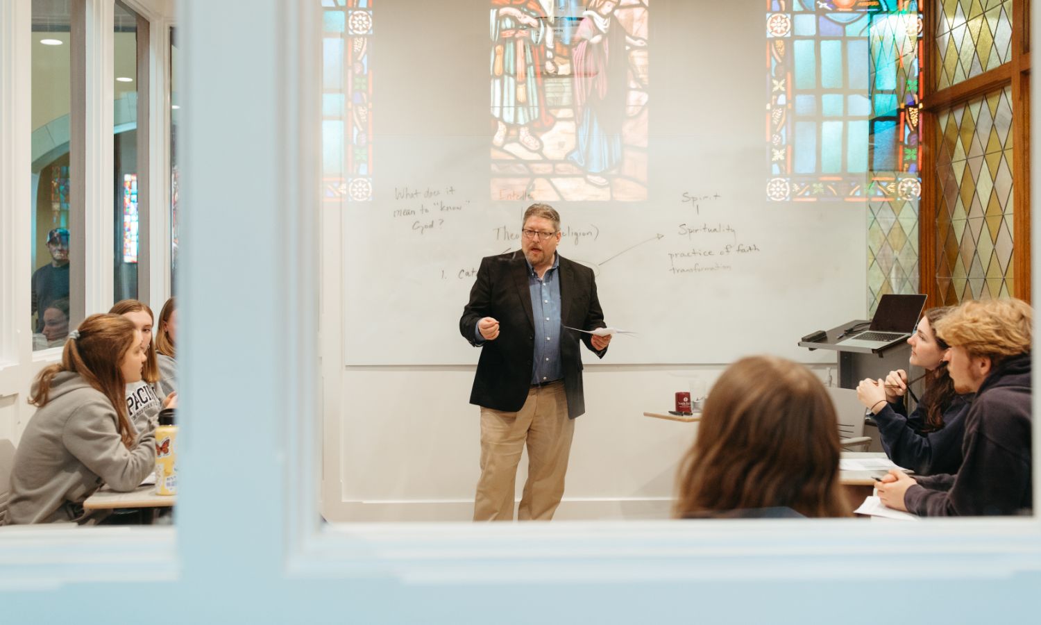 theology teacher leading classroom